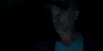 Movie still from “Demonic” (2021), directed by Neill Blomkamp – A person wearing a cap; Close Up shot, Low angle