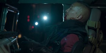 Movie still from “Demonic” (2021), directed by Neill Blomkamp – A man with a bloody head and face in the back of a car; Close Up shot, Over the shoulder angle