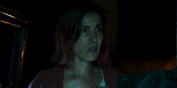 Movie still from “Demonic” (2021), directed by Neill Blomkamp – A person looking at a cell phone; Close Up shot, Low angle