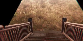 Movie still from “Demonic” (2021), directed by Neill Blomkamp – A view from the top of a wooden stair case; Extreme Wide shot, High angle