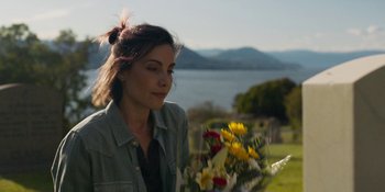 Movie still from “Demonic” (2021), directed by Neill Blomkamp – A woman standing in front of a body of water; Close Up shot, Over the shoulder angle