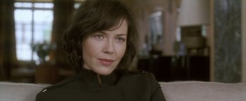 Movie still from “Demonlover” (2002), directed by Olivier Assayas – A person sitting on a couch; Close Up shot, Over the shoulder angle