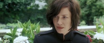 Movie still from “Demonlover” (2002), directed by Olivier Assayas – A person wearing a black jacket; Close Up shot, Over the shoulder angle