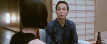 Movie still from “Demonlover” (2002), directed by Olivier Assayas – A man and a woman looking at each other in a mirror; Close Up shot, Over the shoulder angle