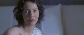 Movie still from “Demonlover” (2002), directed by Olivier Assayas – A person sitting in a chair; Close Up shot, Over the shoulder angle