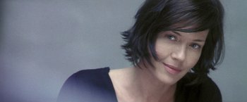 Movie still from “Demonlover” (2002), directed by Olivier Assayas – A person wearing a blue shirt; Close Up shot, Low angle