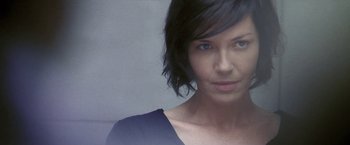 Movie still from “Demonlover” (2002), directed by Olivier Assayas – A person with short black hair; Close Up shot, Low angle