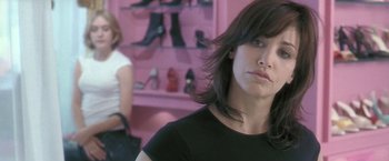 Movie still from “Demonlover” (2002), directed by Olivier Assayas – A person wearing a black shirt; Close Up shot, Over the shoulder angle