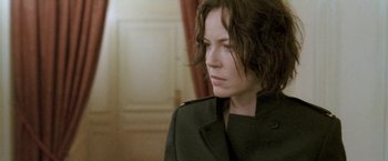 Movie still from “Demonlover” (2002), directed by Olivier Assayas – A person wearing a jacket; Close Up shot, Over the shoulder angle