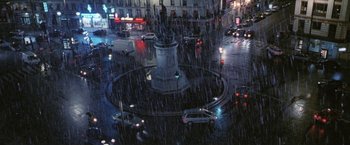 Movie still from “Demonlover” (2002), directed by Olivier Assayas – Cars driving down a street in the rain; Extreme Wide shot, High angle