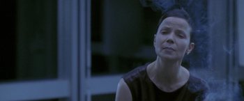 Movie still from “Demonlover” (2002), directed by Olivier Assayas – A woman in a black shirt is looking up; Close Up shot, Low angle