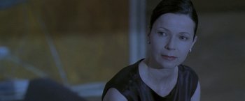 Movie still from “Demonlover” (2002), directed by Olivier Assayas – A person wearing a black shirt; Close Up shot, Over the shoulder angle