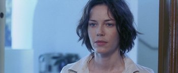 Movie still from “Demonlover” (2002), directed by Olivier Assayas – A person with short hair; Close Up shot, Over the shoulder angle