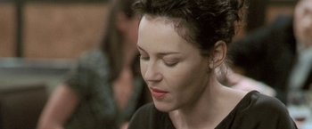 Movie still from “Demonlover” (2002), directed by Olivier Assayas – A person with her eyes closed; Close Up shot, Over the shoulder angle