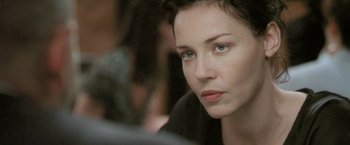 Movie still from “Demonlover” (2002), directed by Olivier Assayas – A person with short black hair; Close Up shot, Over the shoulder angle