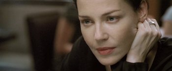 Movie still from “Demonlover” (2002), directed by Olivier Assayas – A woman's face in a black shirt; Close Up shot, High angle