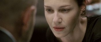 Movie still from “Demonlover” (2002), directed by Olivier Assayas – A woman's face in front of a mirror; Close Up shot, Over the shoulder angle