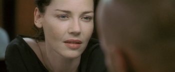 Movie still from “Demonlover” (2002), directed by Olivier Assayas – A woman's face as she looks into a mirror; Close Up shot, Over the shoulder angle
