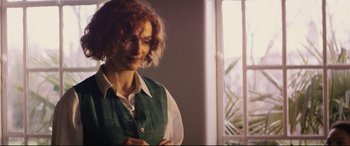 Movie still from “Denial” (2016), directed by Mick Jackson – A woman standing in front of an open window; Medium shot, Over the shoulder angle