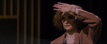 Movie still from “Denial” (2016), directed by Mick Jackson – A woman with her hand up in the air; Close Up shot, Over the shoulder angle