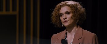 Movie still from “Denial” (2016), directed by Mick Jackson – A person wearing a suit and tie; Close Up shot, Over the shoulder angle