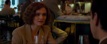 Movie still from “Denial” (2016), directed by Mick Jackson – A person holding a glass of wine; Close Up shot, Over the shoulder angle