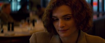 Movie still from “Denial” (2016), directed by Mick Jackson – A person with curly hair; Close Up shot, Over the shoulder angle