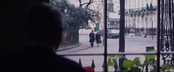 Movie still from “Denial” (2016), directed by Mick Jackson – Two people walking down the street with a suitcase; Wide shot, Over the shoulder angle