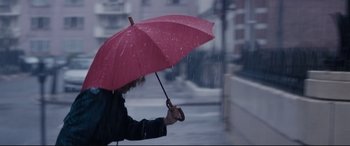 Movie still from “Denial” (2016), directed by Mick Jackson – A person holding an umbrella in the rain; Extreme Close Up shot, Low angle