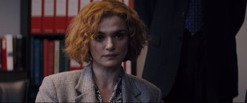 Movie still from “Denial” (2016), directed by Mick Jackson – A person wearing a suit and tie; Close Up shot, Over the shoulder angle
