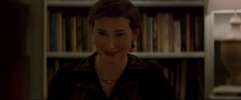 Movie still from “Denial” (2016), directed by Mick Jackson – A person smiling at the camera; Close Up shot, Over the shoulder angle
