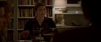 Movie still from “Denial” (2016), directed by Mick Jackson – A woman sitting at a table with two glasses of red wine; Close Up shot, Over the shoulder angle