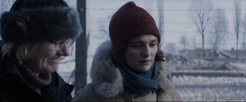 Movie still from “Denial” (2016), directed by Mick Jackson – A woman wearing a red hat and a coat; Close Up shot, Over the shoulder angle