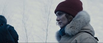 Movie still from “Denial” (2016), directed by Mick Jackson – A woman wearing a red hat and a coat; Close Up shot, Low angle