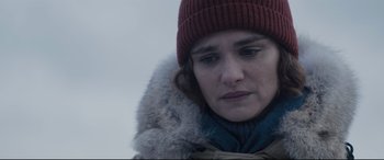 Movie still from “Denial” (2016), directed by Mick Jackson – A person wearing a jacket and a hat; Close Up shot, Over the shoulder angle