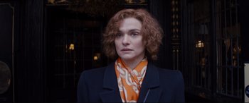Movie still from “Denial” (2016), directed by Mick Jackson – A woman in a jacket and a neck scarf; Close Up shot, Over the shoulder angle