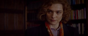 Movie still from “Denial” (2016), directed by Mick Jackson – A person wearing a jacket and a scarf; Close Up shot, Over the shoulder angle