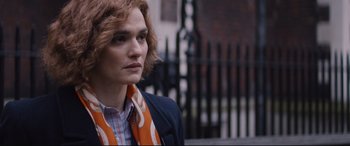 Movie still from “Denial” (2016), directed by Mick Jackson – A person wearing a jacket and a scarf; Close Up shot, Over the shoulder angle