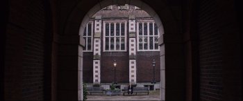 Movie still from “Denial” (2016), directed by Mick Jackson – An archway in front of a brick building; Extreme Wide shot, High angle