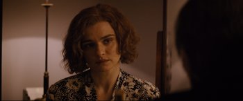 Movie still from “Denial” (2016), directed by Mick Jackson – A person with short hair; Close Up shot, Over the shoulder angle