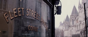 Movie still from “Denial” (2016), directed by Mick Jackson – A sign on the side of a coffee shop window; Extreme Close Up shot, Low angle