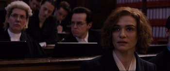 Movie still from “Denial” (2016), directed by Mick Jackson – A group of people sitting in a courtroom; Close Up shot, Over the shoulder angle