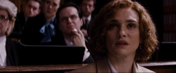 Movie still from “Denial” (2016), directed by Mick Jackson – A group of people sitting in a room with a laptop; Close Up shot, Over the shoulder angle