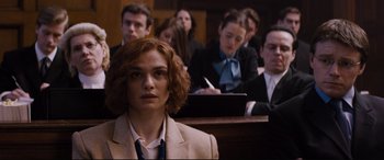 Movie still from “Denial” (2016), directed by Mick Jackson – A group of people sitting in a court room; Medium shot, Over the shoulder angle