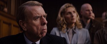 Movie still from “Denial” (2016), directed by Mick Jackson – A man and a woman are looking at the camera; Close Up shot, Over the shoulder angle