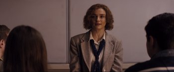 Movie still from “Denial” (2016), directed by Mick Jackson – A woman in a jacket and tie is posing for a picture; Medium shot, Over the shoulder angle