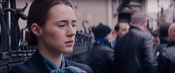 Movie still from “Denial” (2016), directed by Mick Jackson – A person wearing a suit and tie; Close Up shot, Over the shoulder angle