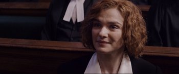 Movie still from “Denial” (2016), directed by Mick Jackson – A person wearing a suit and tie; Close Up shot, High angle