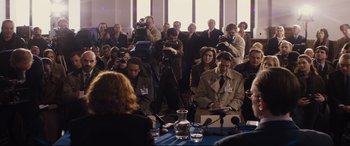 Movie still from “Denial” (2016), directed by Mick Jackson – A group of people standing around a table; Wide shot, Over the shoulder angle