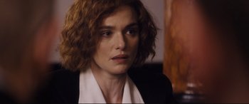 Movie still from “Denial” (2016), directed by Mick Jackson – A person wearing a suit and tie; Close Up shot, Over the shoulder angle